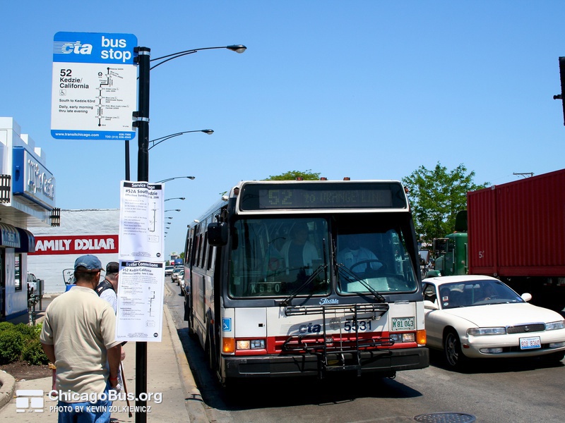 Bus #5531 at Kedzie and Archer, working route #52 Kedzie/California, on June  8, 2006. Starting June 18, 2006 service on the #52 was extended to 63rd St. during all times of service. An updated bus stop sign, along with service alerts detailing both the #52 and #52A route changes can be seen.