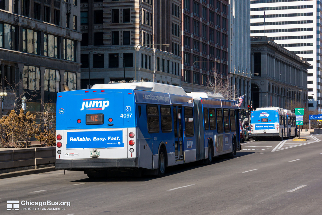 Bus #4097 at Michigan and Madison, working route #J14 Jeffery Jump, on January 16, 2013. In the distance is bus #4085.