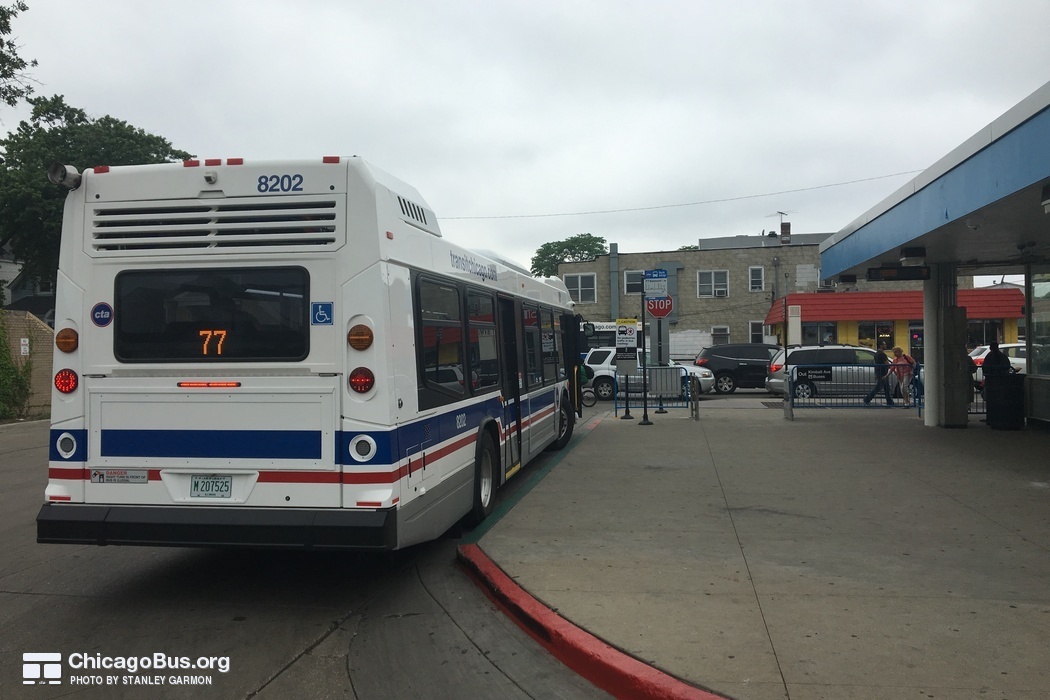 Bus #8202 at Belmont and Kimball (Blue Line Station), working route #77 Belmont, on June  4, 2016.