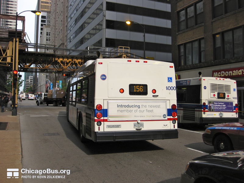 Bus #4000 at Adams and Wells, working route #156 LaSalle, on June  3, 2009. This bus originally shipped with unnecessary rear vents, similar to the 1000-series seen to its right. New Flyer later replaced replaced the rear panel to match the rest of the 4000-series deliveries.