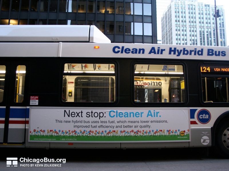 Bus #809 at South Water and Michigan, working route #124 Navy Pier, on March 10, 2007. The lettering "Clean Air Hybrid Bus" and an accompanying advertisement inform the public that this is a special bus.